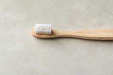 Natural bamboo toothbrush on minimalist background emphasizes ec