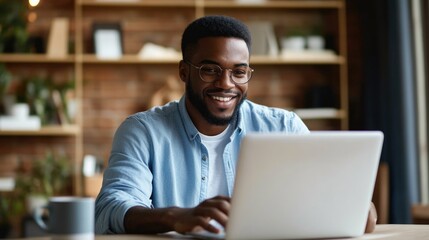 Smiling Young Professional Using Laptop in Office