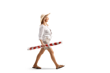 Woman carrying a beach umbrella and walking