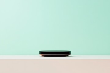 presentation setup featuring sleek modern object placed centrally on neutral surface set against light green chroma