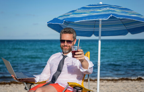 Business man use laptop in beach. Travel and business. Man freelance worker online at sea. Businessman on summer. Online freelance work. Businessman office worker with laptop. Business lounge access