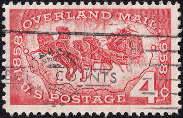 U.S. postage stamp commemorating Overland Mail, 1858-1958. Features a stagecoach pulled by horses, symbolizing early mail transportation across the American frontier. Issued in 1958, USA.