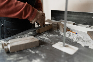 carpenter cutting wood with saw