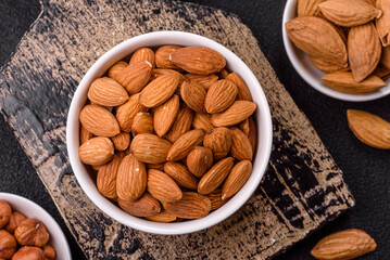 Roasted or raw peeled almonds in bowl