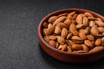 Roasted or raw almond nuts in shell in bowl