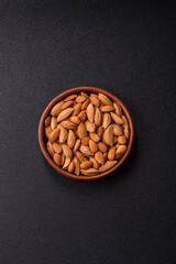 Roasted or raw almond nuts in shell in bowl