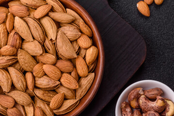 Roasted or raw almond nuts in shell in bowl