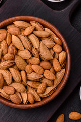 Roasted or raw almond nuts in shell in bowl