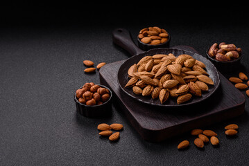 Roasted or raw almond nuts in shell in bowl