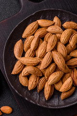 Roasted or raw almond nuts in shell in bowl