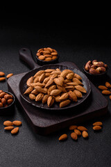 Roasted or raw almond nuts in shell in bowl