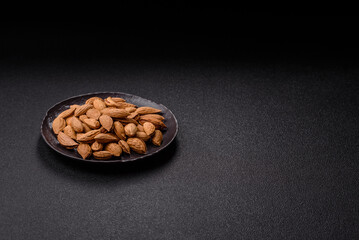 Roasted or raw almond nuts in shell in bowl