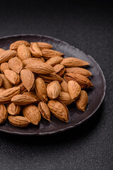 Roasted or raw almond nuts in shell in bowl