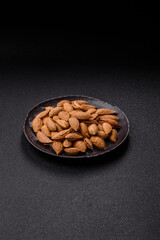 Roasted or raw almond nuts in shell in bowl