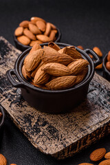 Roasted or raw almond nuts in shell in bowl