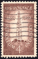 Obraz premium Vintage U.S. postage stamp commemorating the centennial of the petroleum industry, issued in 1959. Features an oil derrick with industrial buildings. A tribute to energy history.