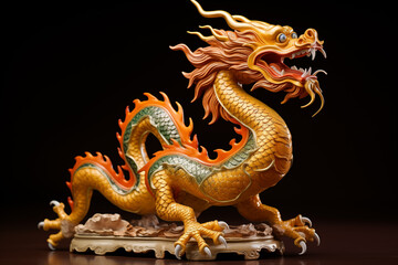 Fototapeta premium A vibrant ceramic dragon figurine displays intricate detailing and colors. Perfect for cultural decor or artistic collections, set against a dark background.