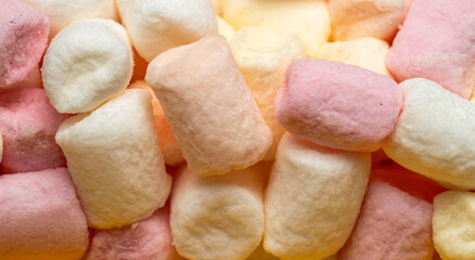 colorful marshmallow pieces in vertical stack, banner background in pastel colors, full frame