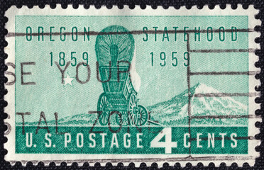U.S. stamp issued in 1959 celebrating Oregon’s centennial of statehood, featuring a covered wagon...