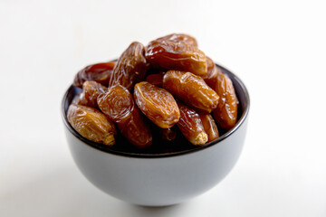 Delicious dates in a bowl on white. High quality photo