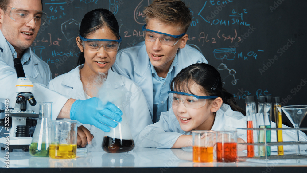 Poster girl looking at beaker while doing experiment at blackboard with chemistry theory in stem class. tea
