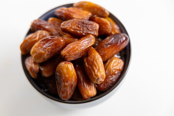 Delicious dates in a bowl on white. High quality photo