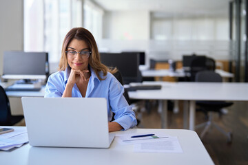 Happy busy smiling mature middle aged professional business woman manager executive or company...
