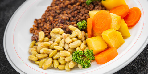 Lentils and vegetables vegetarian main course, bean, potatoe, carrot tasty fresh gourmet food background on the table rustic food top view copy space keto and paleo diet vegetarian and vegan food