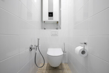 White toilet bowl in the bathroom interior