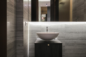 Faucet with ceramic sink and mirror in the bathroom