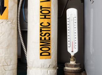 Thermometer too low on hot water tank in boiler room of building. Repair broken hot hot water...