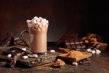 Hot chocolate drink with marshmallows on a brown background.