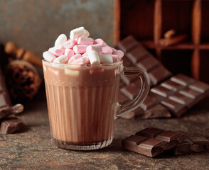 Hot chocolate drink with marshmallows on a brown background.