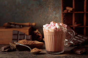 Hot chocolate drink with marshmallows sprinkled with cocoa powder.