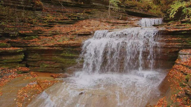 4K footage showcasing the vibrant autumn leaves in Buttermilk Falls State Park, Ithaca, NY. A stunning view of red, yellow, and orange hues transforming the landscape during fall