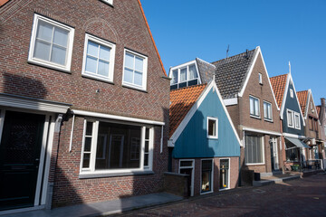 Tourists destination in North Holland, old authentic fishermen village Volendam near Amsterdam with old houses and narrow streets