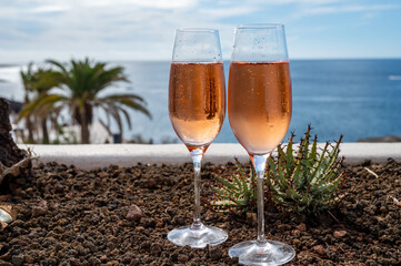 Celebration, birthday party, drinking of rose cava or champagne sparkling wine in vacation resort Costa Adeje, Tenerife, Canary islands winter sun vacation, Spain
