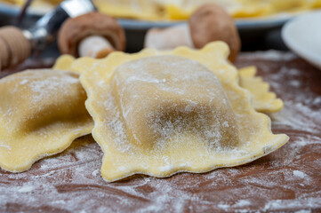Italian food, fresh home made stuffed pasta ravioli dumplings with ricotta soft cheese and champignons porcini mushrooms, Parma, Emilia Romagna, Italy