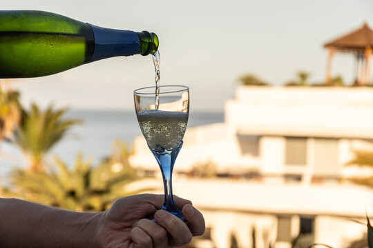 Celebration, birthday party, drinking of cava or champagne sparkling wine in vacation resort Costa Adeje, Tenerife, Canary islands winter sun vacation, Spain