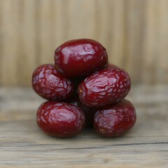 Obraz premium Juicy Red Dates Stacked on Rustic Wood Closeup
