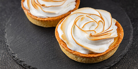 Lemon tart sweet dessert meringue, lemon curd tasty fresh gourmet food background table rustic food top view copy space