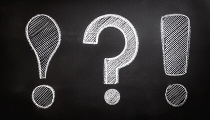 white chalk drawing of question mark exclamation mark and three point on black grunge background