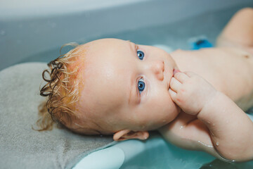 A joyful baby is enjoying a relaxing bath time experience that brings delight and comfort