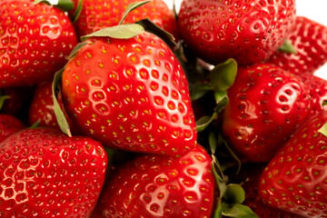 Close-up image showcases a selection of fresh, vibrant, ripe strawberries.
