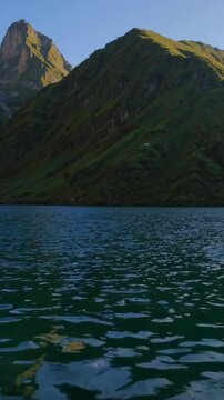 Vertical screen, mountain lake surface reflecting surrounding swiss alps, with prominent santis peak standing tall against serene landscape of seealpsee