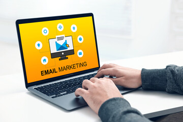 Email marketing. Man using laptop at table, closeup