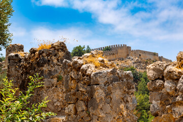 Landscape view old walls of fortress on Mediterranean coast. View of Alanya Castle, stone ruins in Alanya, Turkey. High quality photo