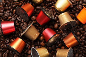 Many coffee capsules on beans, top view