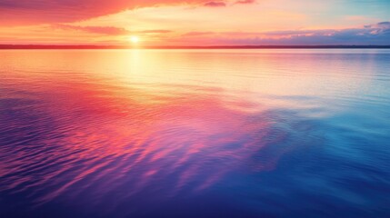 Fototapeta premium A serene landscape with a warm sunset over calm water