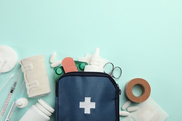First aid kit. Different medical supplies on light blue background, flat lay. Space for text